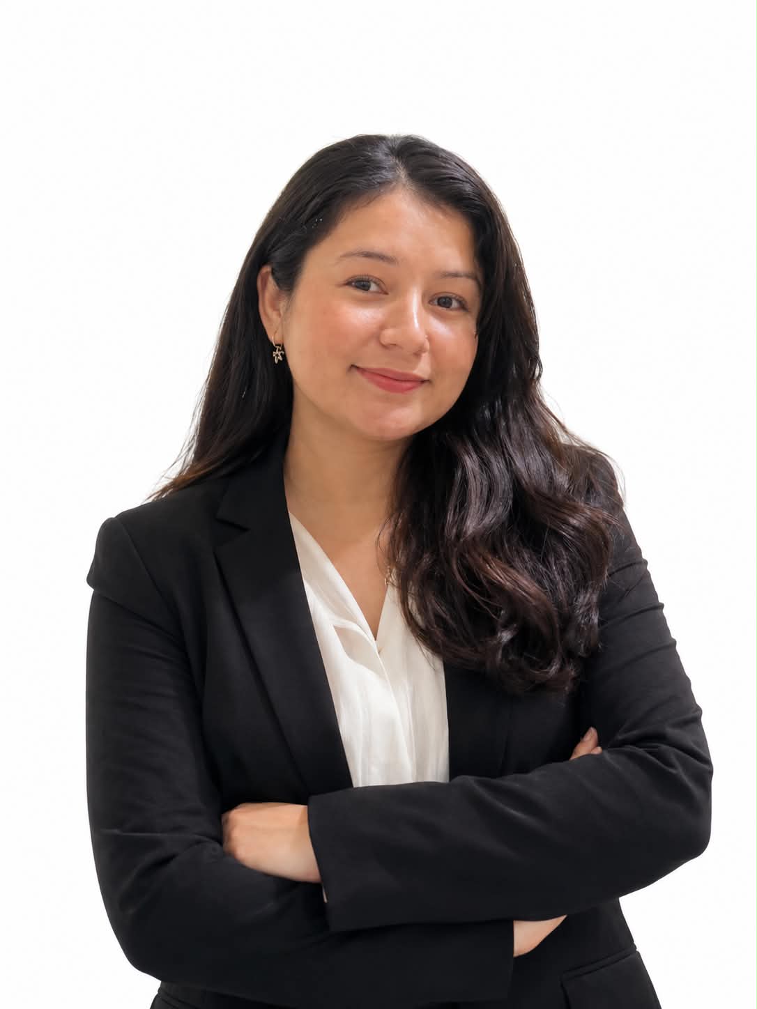 Portrait of Rojina in a black blazer, arms crossed